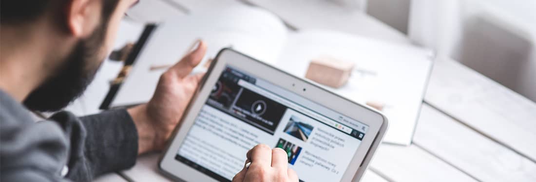 bearded man using a tablet
